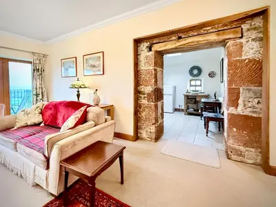 a living room with a couch and a table at Townhead Mill in Dumfries
