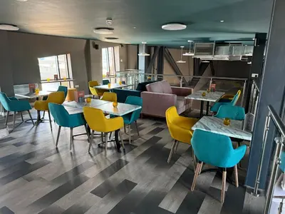 a restaurant with tables and chairs and a couch at The Edge in Whitehaven