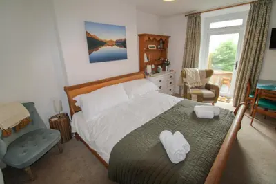 a bedroom with a bed with two towels on it at Lorton View, nestles on the fellside with walks from the door close to Lorton in Lorton