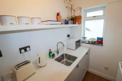 a small kitchen with a sink and a window at Lorton View, nestles on the fellside with walks from the door close to Lorton in Lorton