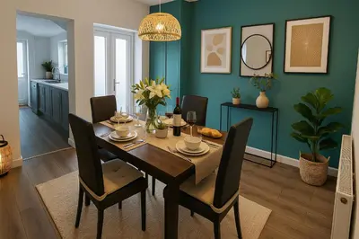 a dining room with a wooden table and chairs at Armstrong St - Cosy 3 Bedroom Home in Workington