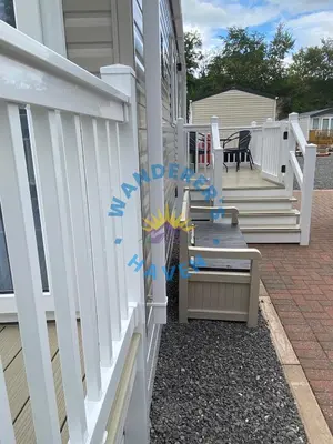 a white fence on the side of a house at Wanderers Haven, Brigham, Cockermouth, Cumbria in Brigham