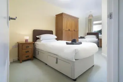 a bedroom with two beds with white sheets and white pillows at 22 Thrang Brow - Langdale Valley in Chapel Stile