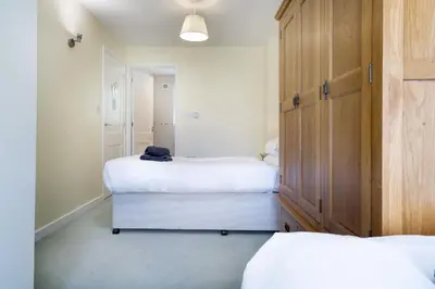 a bedroom with two beds and a closet at 22 Thrang Brow - Langdale Valley in Chapel Stile