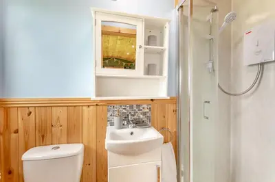 a bathroom with a toilet and a sink and a mirror at 1 Bed in Keswick oc-c33119 in Bassenthwaite