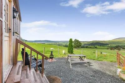 a view from the porch of a house with a picnic table at 1 Bed in Keswick oc-c33119 in Bassenthwaite