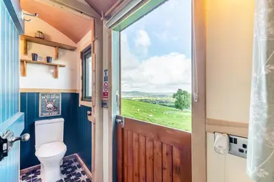 a bathroom with a toilet and a door with a view at 1 Bed in Keswick oc-f33118 in Bassenthwaite