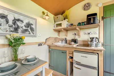 a kitchen with blue and green cabinets and a counter at 1 Bed in Keswick oc-f33118 in Bassenthwaite