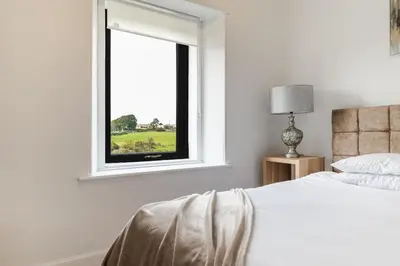 a bedroom with a bed and a window at 2Bedroom House - Free Parking- by Holiday Homes in Annan
