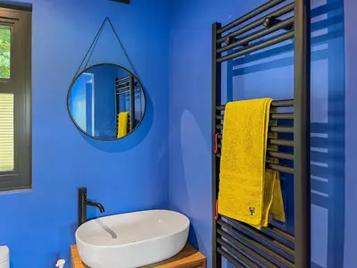 a blue bathroom with a sink and a mirror at Cassiopeia - Uk50360 in Castle Douglas