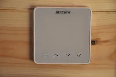 a white switch on a wooden table at Burnside of Ae Glamping Shepherd's Hut in Dumfries