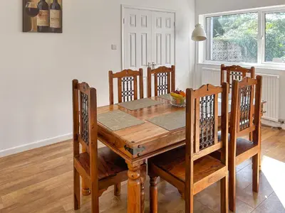 a dining room table with chairs and a wooden table at Revita in Egremont