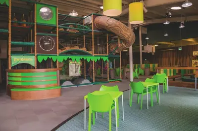 a playground with green tables and chairs and a slide at A&L Holiday Home Craigtara in Ayr