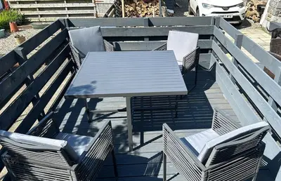 a picnic table and chairs on a wooden deck at The Attic Portpatrick in Portpatrick