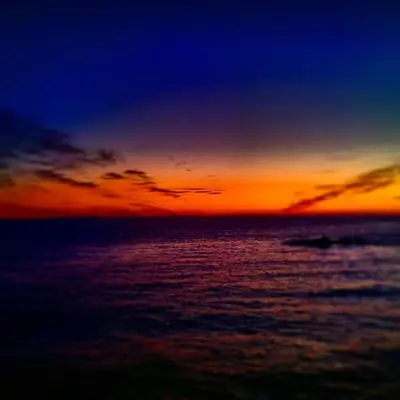 a sunset over the ocean with the sky at The Attic Portpatrick in Portpatrick
