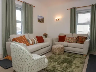 a living room with a couch and a chair at Cosy Cottage in Cumbria, West of Lake District in Broughton Moor