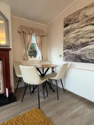 a dining room with a table and chairs at Cosy Caravan by the sea in Cairnryan