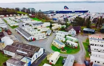 an aerial view of a town with a cruise ship at Cosy Caravan by the sea in Cairnryan