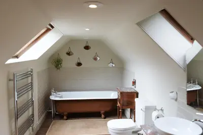 a bathroom with a tub and a toilet and a sink at The Coach House in Castle Douglas