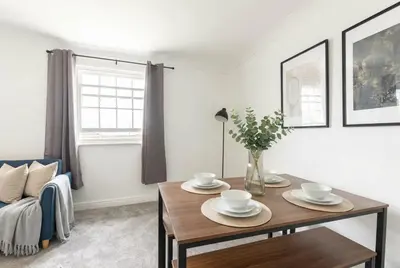 a living room with a table and a couch at Fabulous 1 Bed Harbour-side Apartment with Balcony in Whitehaven