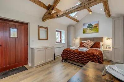 a bedroom with a bed and a wooden door at 1 Bed in Wetheral oc-r32933 in Wreay