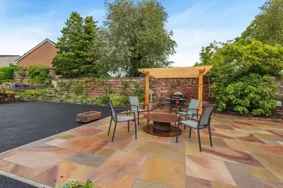 a patio with a table and chairs and a brick wall at 1 Bed in Wetheral oc-r32933 in Wreay