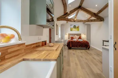 a kitchen and living room with a bed in the background at 1 Bed in Wetheral oc-r32933 in Wreay