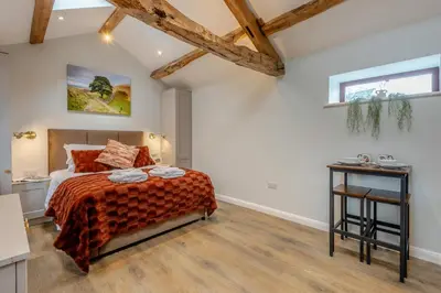 a bedroom with a bed and a wooden floor at 1 Bed in Wetheral oc-r32933 in Wreay