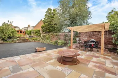 a patio with a grill and a wooden pergola at 1 Bed in Wetheral oc-g32934 in Wreay