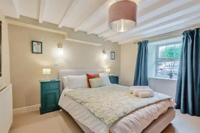 a bedroom with a large bed and a window at 4 Bed in Ellonby oc-y33284 in Ellonby
