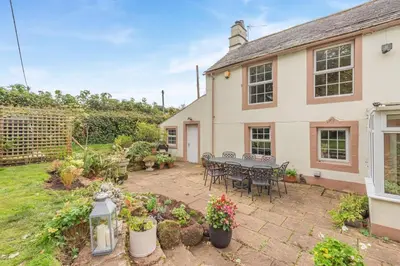 a patio with a table and chairs in front of a house at 4 Bed in Ellonby oc-y33284 in Ellonby