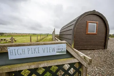 a sign on a fence next to a small building at Unit 3 - High Pike View Camping Pod in Carlisle