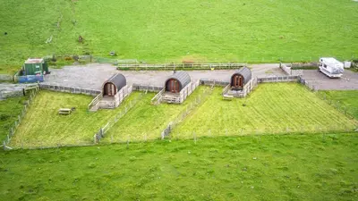 an aerial view of a farm with tents in a field at Unit 3 - High Pike View Camping Pod in Carlisle