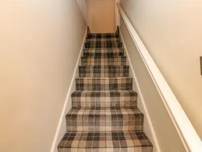 a flight of stairs with a plaid carpet at Milford in Carlisle