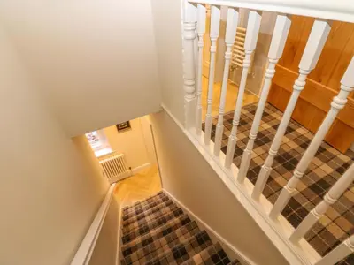 a staircase with white railings and tile floors at Milford in Carlisle