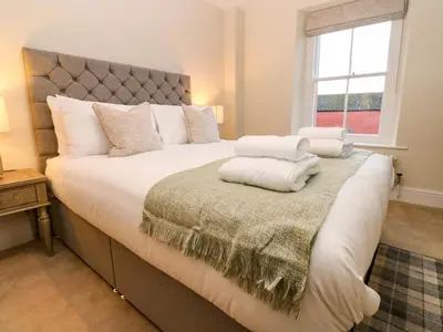 a bedroom with a large bed with white pillows at Milford in Carlisle
