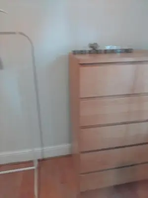 a chest of drawers in a room with a wall at 3 Bedroom house Abbey wood London in Moffat