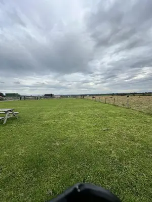 a picnic table in the middle of a field at Unit 0 - Fully Serviced All Weather Pitch with Hot Tub in Carlisle