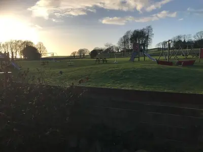 a park with a playground with a slide at Evas cottage near Scafell in Gosforth