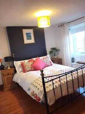 a bedroom with a bed with pillows on it at Evas cottage near Scafell in Gosforth