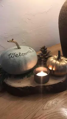 a table with some candles and pumpkins on it at Evas cottage near Scafell in Gosforth