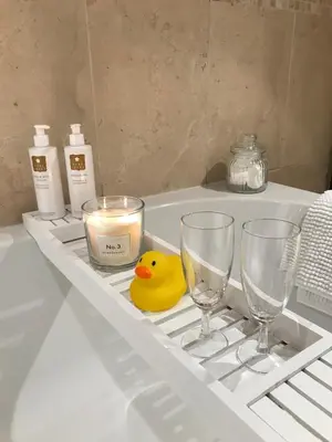 a rubber duck sitting on a shelf with two glasses and a candle at Evas cottage near Scafell in Gosforth