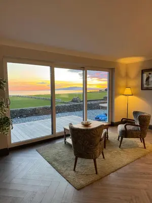 a living room with a large window with a view at Rumblekirn in Annan