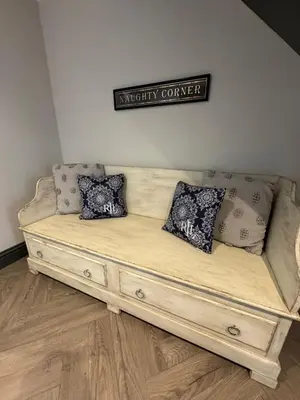 a couch with pillows on it in a room at Rumblekirn in Annan