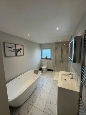 a bathroom with a tub and a toilet and a sink at Rumblekirn in Annan