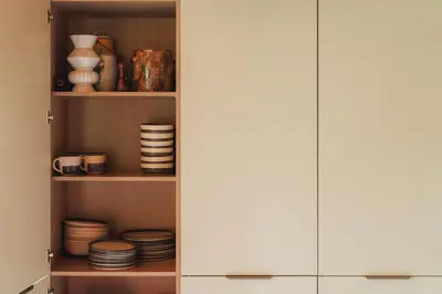 a cupboard filled with plates and bowls at The Hideaway at Yew Trees, Ullswater in Watermillock