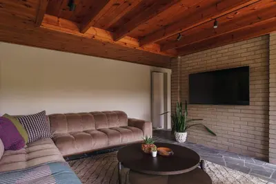 a living room with a couch and a flat screen tv at The Hideaway at Yew Trees, Ullswater in Watermillock