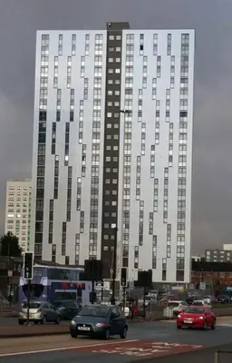 a large building with cars driving in front of it at Pazuri Apart in Moffat