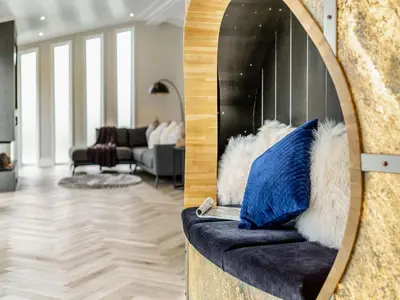 a living room with a couch with a mirror at Landal North Lakes