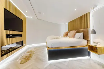 a bedroom with a bed and a tv on a wall at Landal North Lakes
